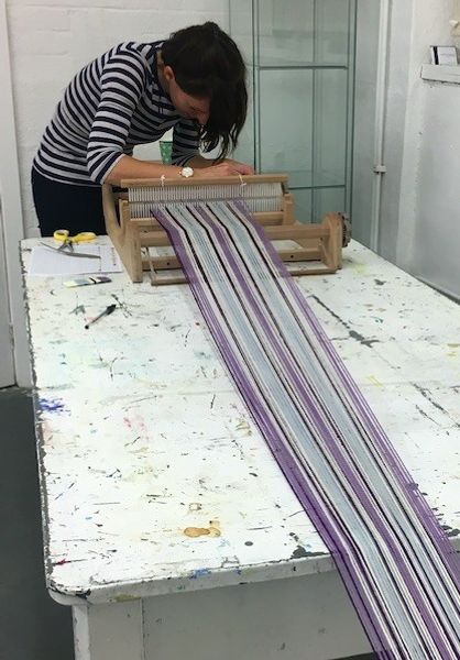 A student making a warp in the Pattern weaving course
