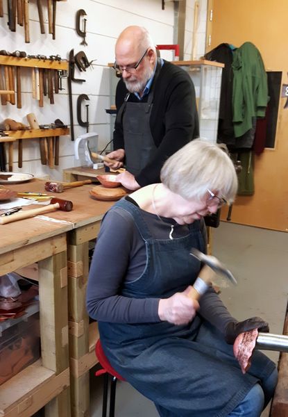 Different stages of the process. Tom is caulking the edge of his bowl to prevent it from thinning. Lynne is finnishing a course of raising.
