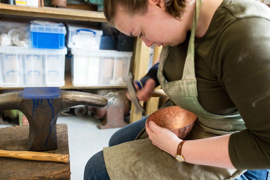 (DEMO) Caulking the edge of the copper bowl to stop it thinning. [Photo Credit: Ben Boswell]