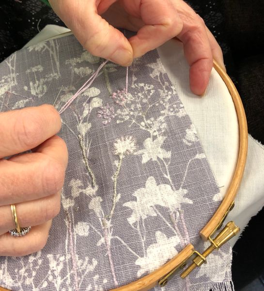 Hand sewing onto a printed fabric 