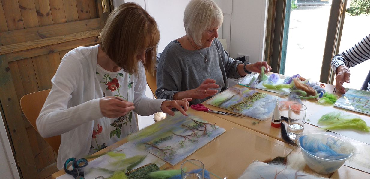 students making wool fibre paintings with artist Raya Brown