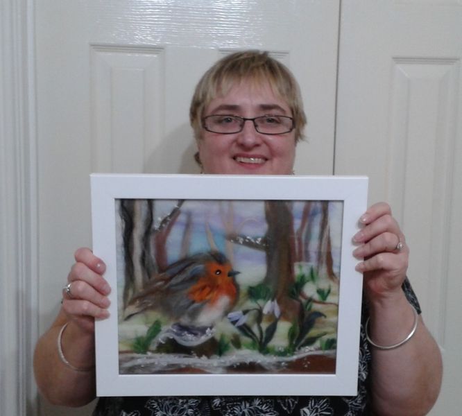 Student with her wool painting created at the wool painting art textiles course in Worcestershire