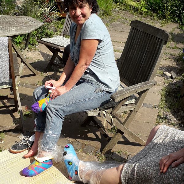 Sitting in the sun and shrinking their slippers to fit.