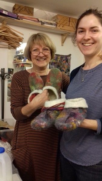 Ewa and Ema displaying their finished slippers.