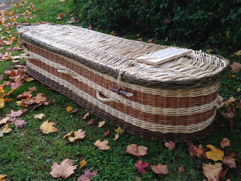 Finished coffin with plaited border, rope handles and clasps