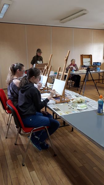 Students painting in a relaxed atmosphere