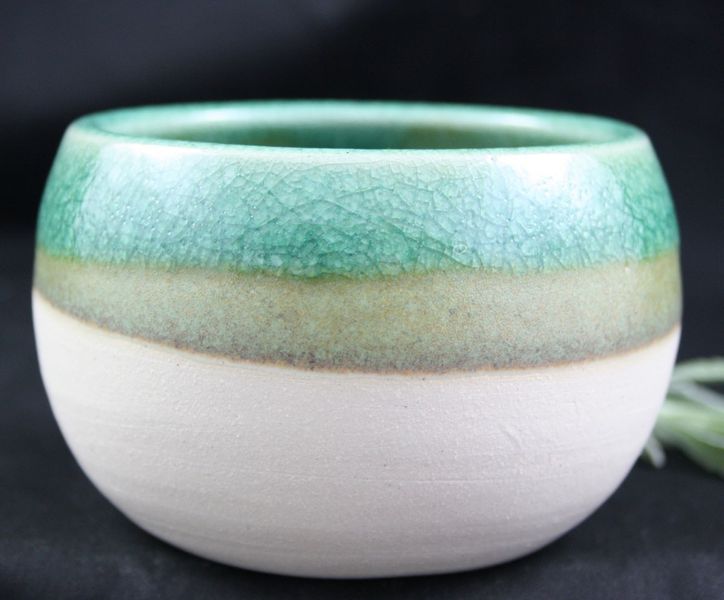 Stoneware, thrown and glazed pot - available on our website.