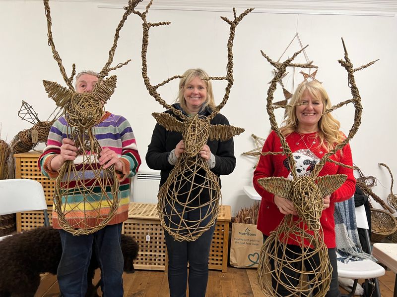 happy students with ethical trophy stag heads