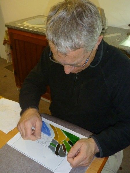 A landscape panel being made using glass appliqué.