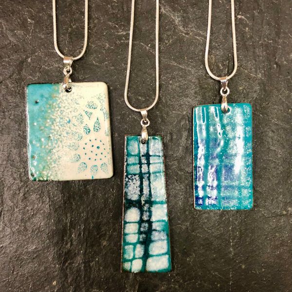 Three aqua blue and white pendants, same enamels different effects! Individual ideas flourishing on our enamelling day course for beginners! 