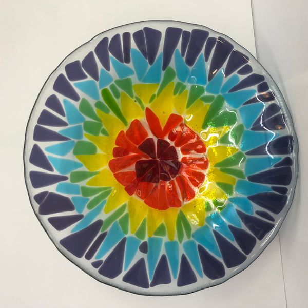 Fused glass rainbow flower bowl made by Joanne on our beginners day course at Rainbow Glass Studios