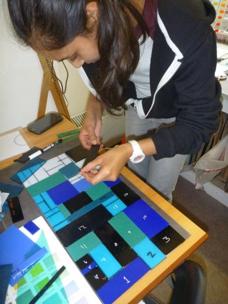 Under-18s can do glass fusing and glass appliqué by arrangement; here a student works on a fused glass clock for a school project.