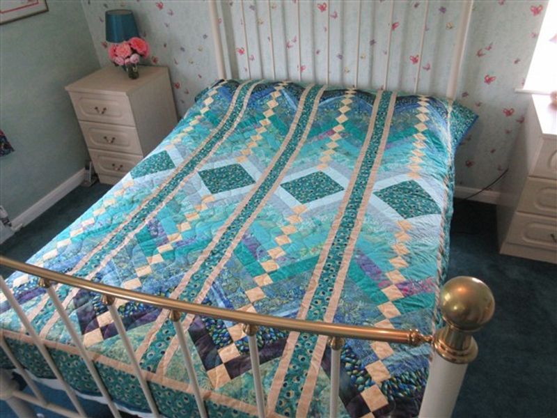 Stunning double bed quilt in peacock colours