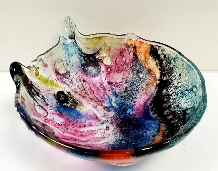 A Fused Glass slump bowl inspired by the Northern Lights, made by Melanie the workshop facilitator.