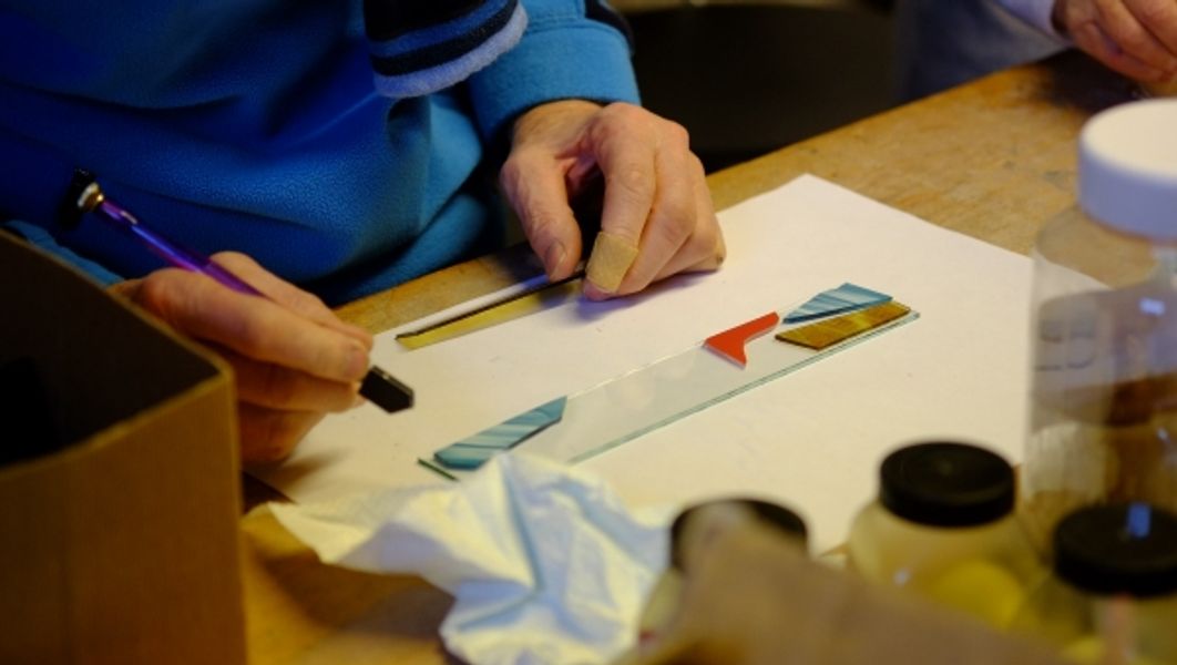 Student at work on a fused glass taster