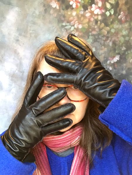 Elizabeth posing artistically with her black gloves.