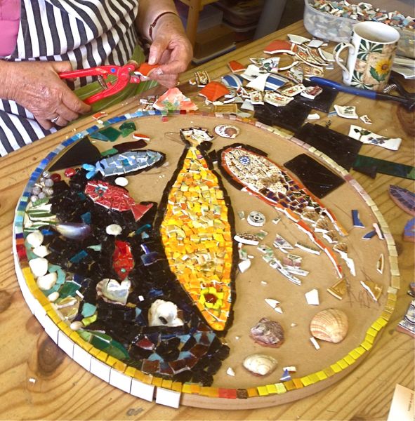 Mixed media mosaic made using stained glass, vitreous glass tiles, shells, stones, china and beads.