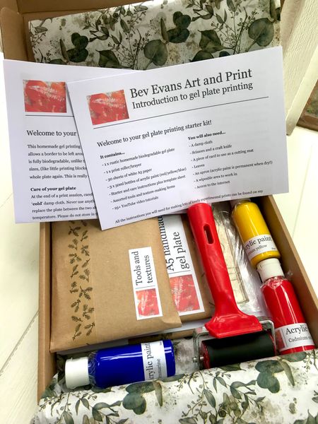 Contents of the kit, in the box, including paint, roller, paper, gel plate, tools/textures and instructions