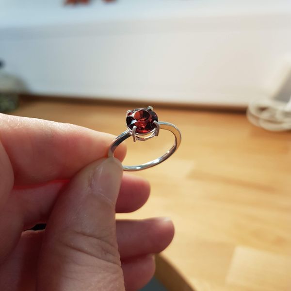 A student's repurposed garnet in a claw setting