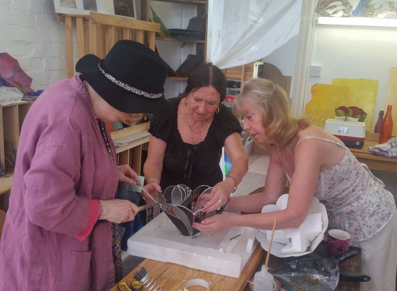 Assisting in assembling a lamp-shade, student work