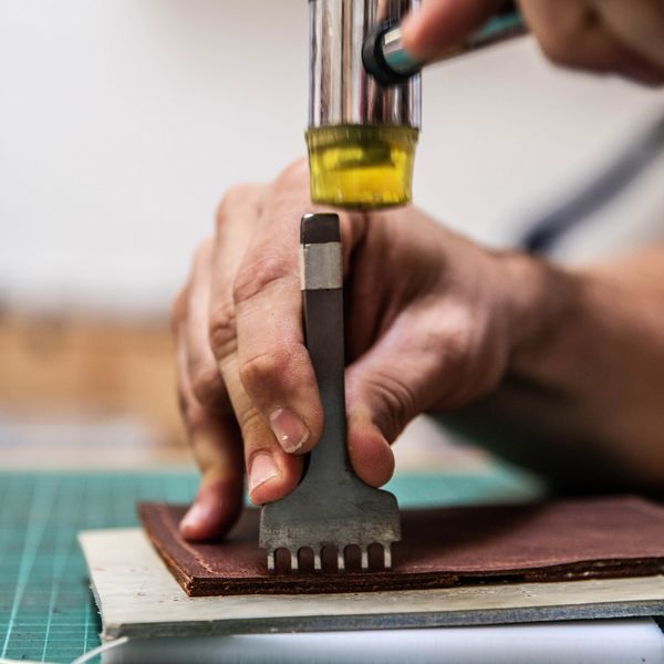 Hole punching leather with a pricking iron and mallet