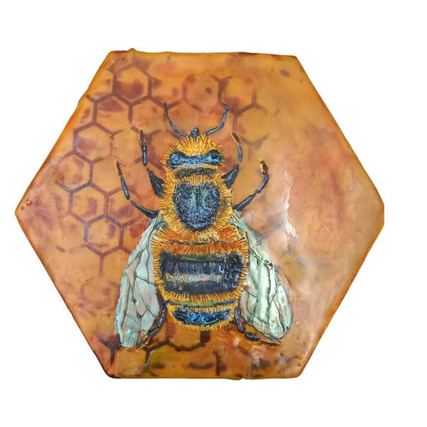 Bee created with encaustic stylus on hexagonal panel.