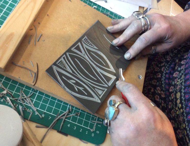 Cutting a lino block.