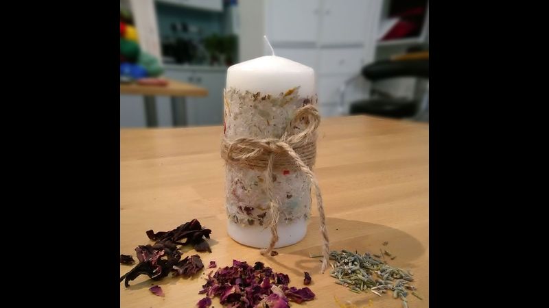 A candle wrapped in handmade paper