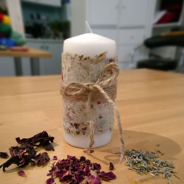 A candle wrapped in handmade paper