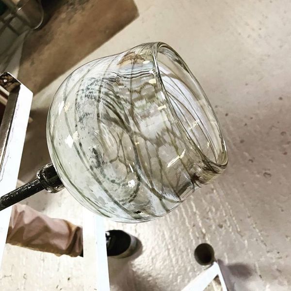 Student finishing a blown glass bowl