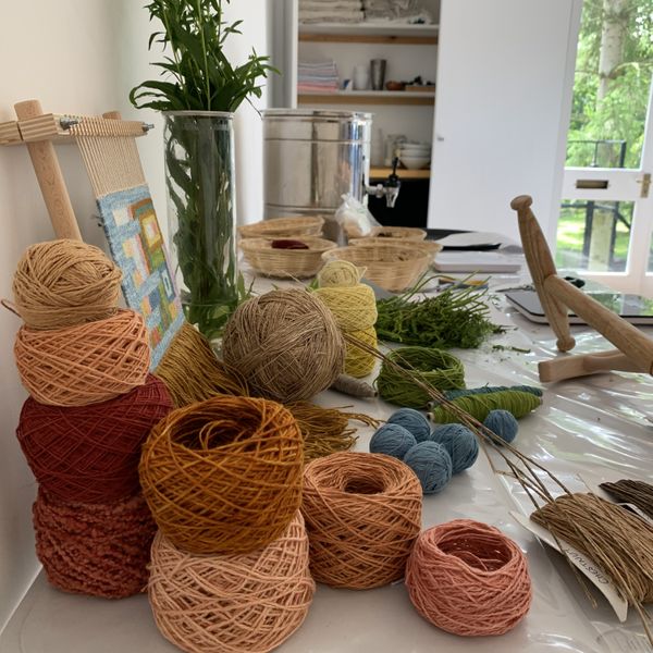 Display table of raw materials and naturally dyed yarn