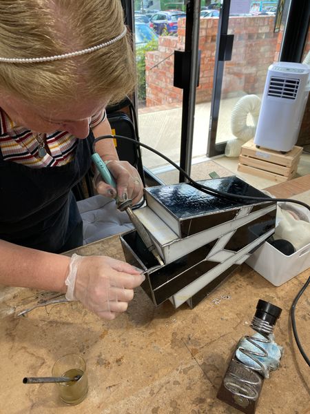 Karen soldering her Art Deco Lamp