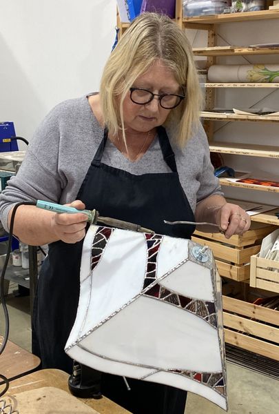 Christine soldering her lamp