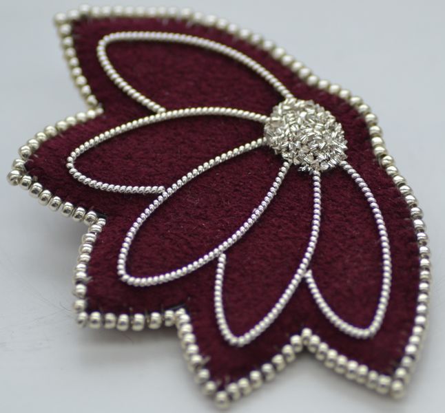 Silver brooch in burgundy