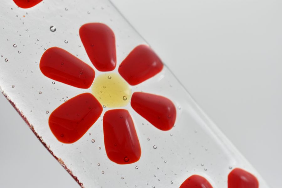 Bright red flowers on a fused glass suncatcher