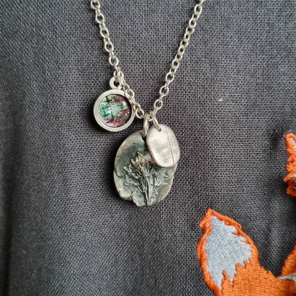 Creating a charm necklace with different types of silver clay pendants.