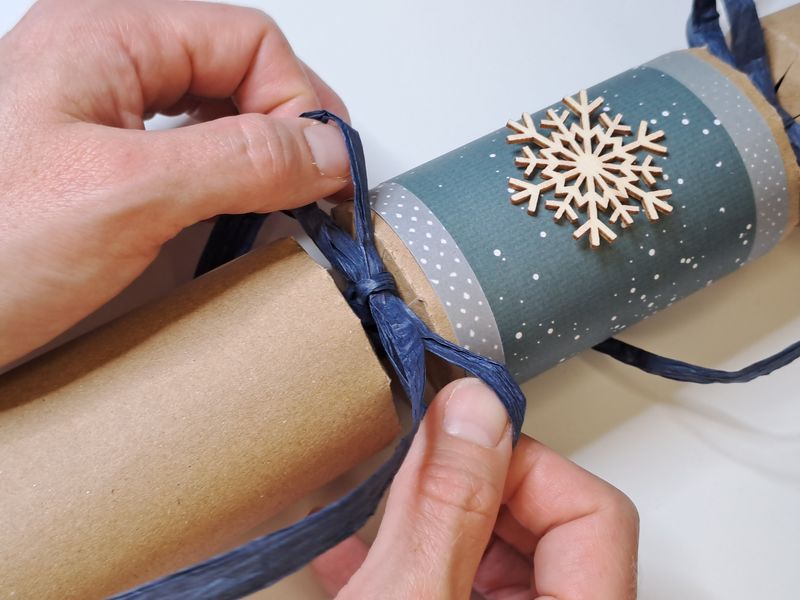 Tying a bow on a Christmas cracker