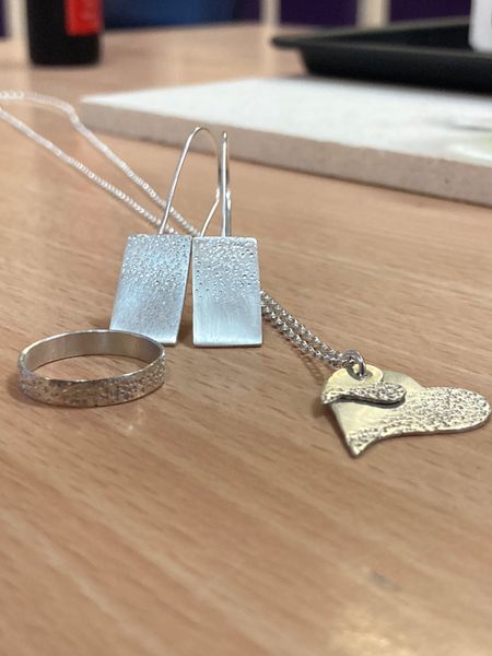 Collection of jewellery created on a beginners silver jewellery course.