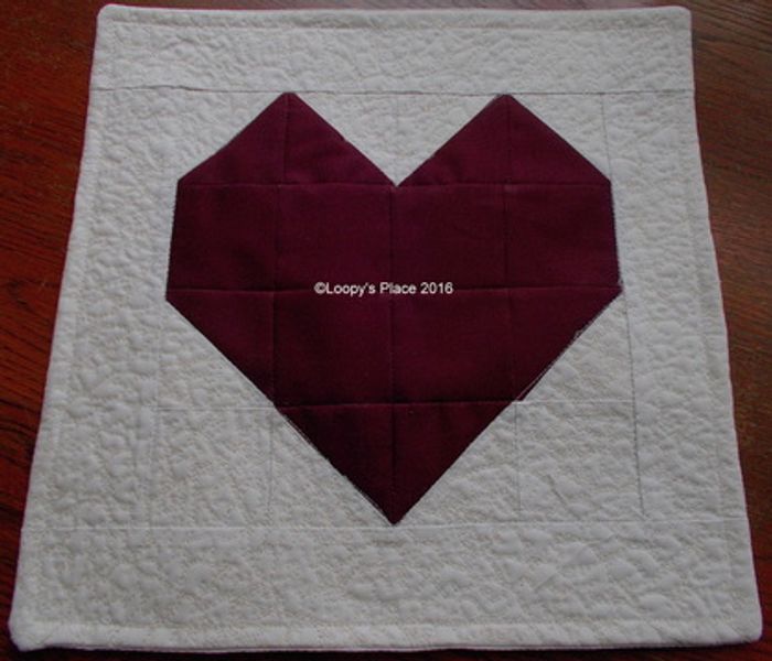 Create a patchwork heart cushion or wall hanging 