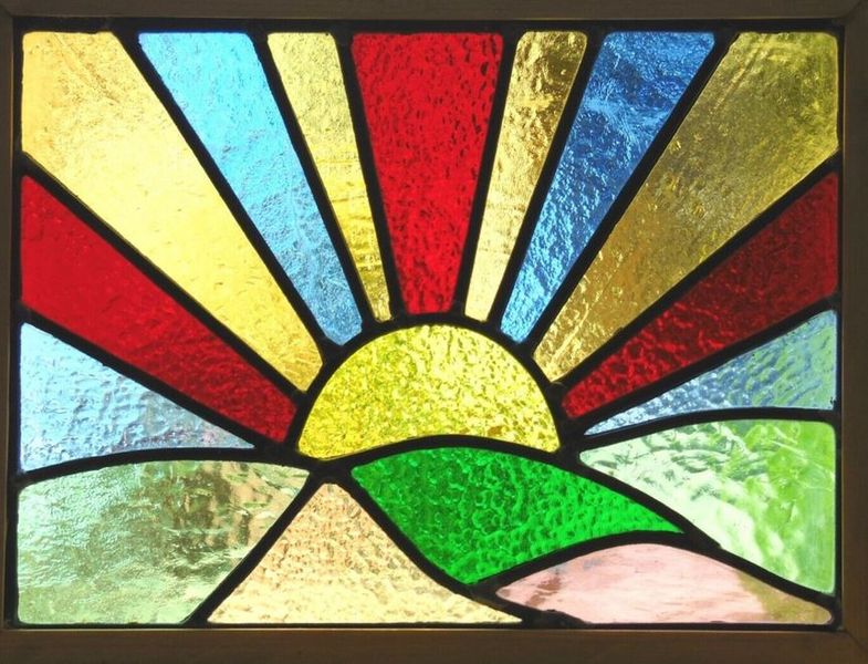 Leaded stained glass panel of a sunrise.
