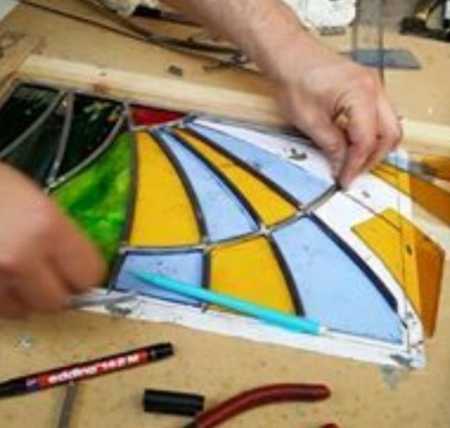 Stained glass panel being assembled with lead cames.
