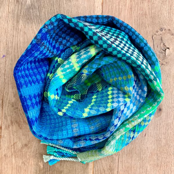 Hand woven scarf, coiled up.