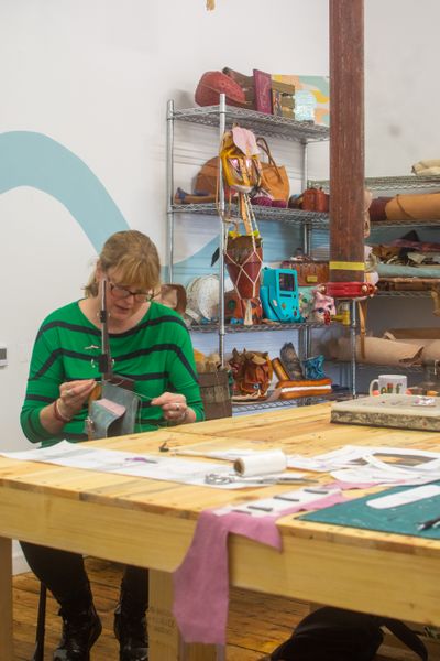 A leathercraft student sewing