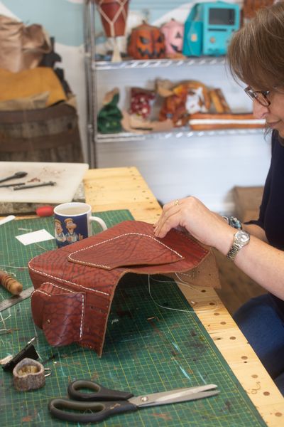 A student sewing her bag