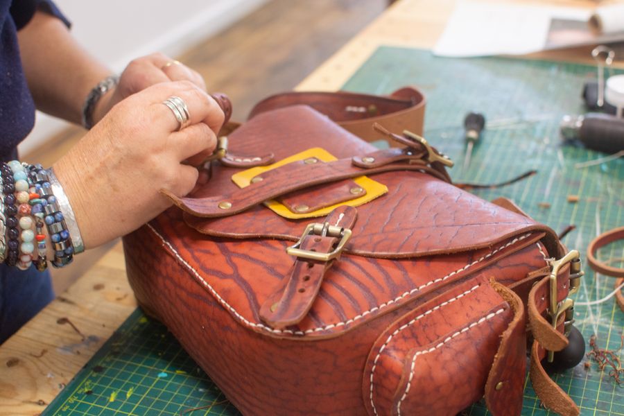 A student finishing her bag on the 3 day leather bag making workshop