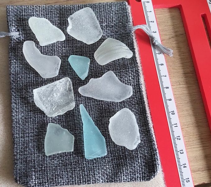 ECO SEA GLASS PIECES VARIOUS WITH A RULER IN PHOTO TO SHOW THE SIZE OF YOUR HESSIAN BAG AND GIVE YOU AN IDEA OF THE SEA GLASS SIZES TOO.