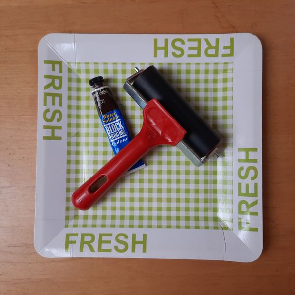 A paper print tray, printing ink and a brayer.