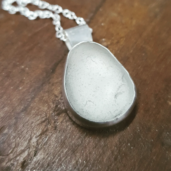 white seaglass pendant on bench