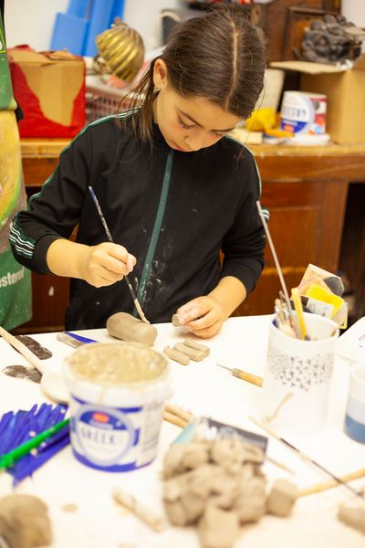 Child making ceramic animal