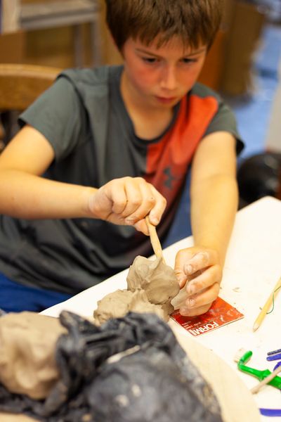 Child creating in clay